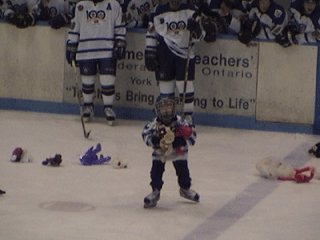 Using both hands, this Novice Waxer loads up on stuffed animals thrown during the Teddy Bear Toss.